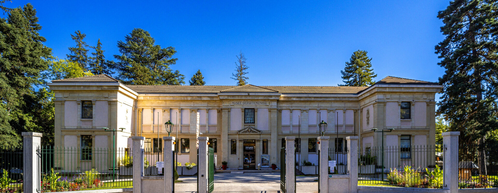 La façade externe du bâtiment vue de face sous un beau ciel bleu.